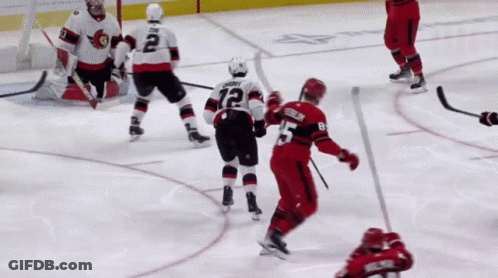 A Hockey Player With The Number 12 On His Jersey Stands On The Ice GIF