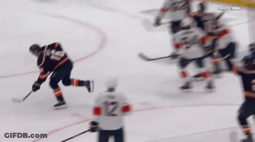 A Hockey Player With The Number 12 On The Back Of His Shirt GIF