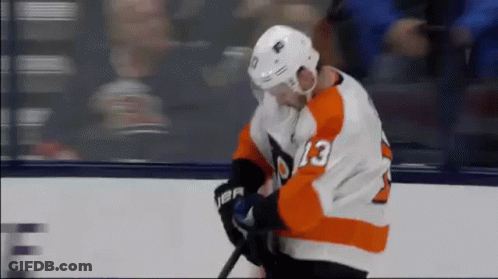 A Hockey Player With The Number 13 On His Jersey Is Holding A Stick . GIF