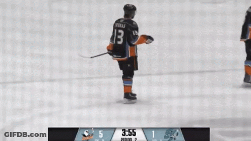 A Hockey Player With The Number 13 On His Jersey Is Standing On The Ice GIF