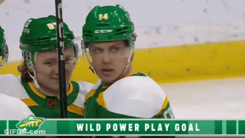 A Hockey Player With The Number 14 On His Helmet Stands Next To Another Player GIF