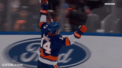 A Hockey Player With The Number 14 On His Jersey Is Celebrating GIF
