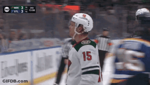 A Hockey Player With The Number 15 On His Jersey Stands On The Ice GIF