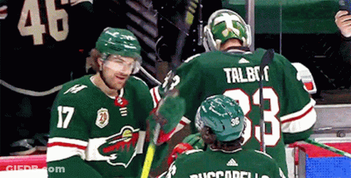 A Hockey Player With The Number 17 On His Jersey Talks To Another Player GIF