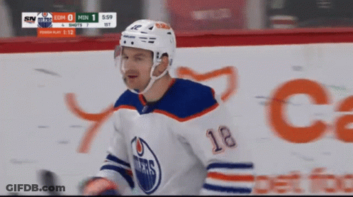 A Hockey Player With The Number 18 On His Chest GIF