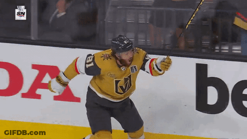 A Hockey Player With The Number 18 On His Jersey Celebrates His Goal GIF