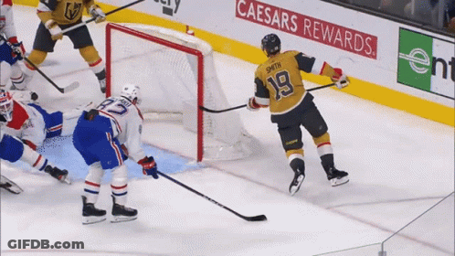 A Hockey Player With The Number 18 On His Jersey Stands On The Ice GIF