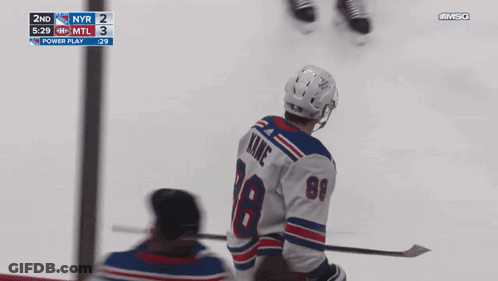 A Hockey Player With The Number 18 On His Jersey Stands On The Ice GIF