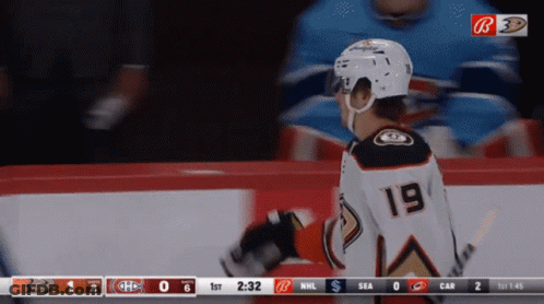 A Hockey Player With The Number 19 On His Back GIF