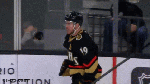 A Hockey Player With The Number 19 On His Jersey Is Walking On The Ice GIF