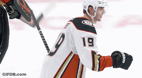 A Hockey Player With The Number 19 On His Jersey Stands On The Ice GIF