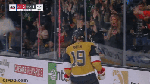 A Hockey Player With The Number 19 On His Jersey Stands On The Ice GIF