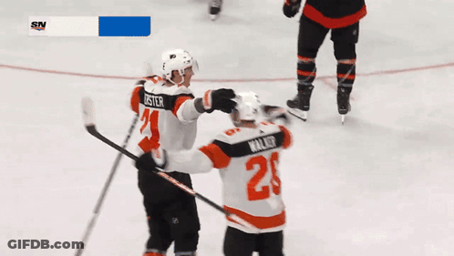 A Hockey Player With The Number 2 On His Jersey Hugging Another Player GIF