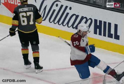 A Hockey Player With The Number 20 On His Jersey Falls On The Ice GIF