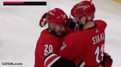 A Hockey Player With The Number 20 On His Jersey Is Hugging Another Hockey Player With The Number 11 On His Jersey GIF