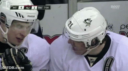 A Hockey Player With The Number 21 On His Helmet Talks To Another Hockey Player GIF