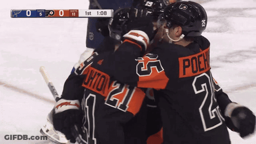 A Hockey Player With The Number 21 On His Jersey Hugs Another Player GIF