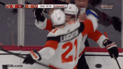 A Hockey Player With The Number 21 On His Jersey Is Hugging Another Player GIF