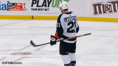 A Hockey Player With The Number 21 On His Jersey Stands On The Ice GIF