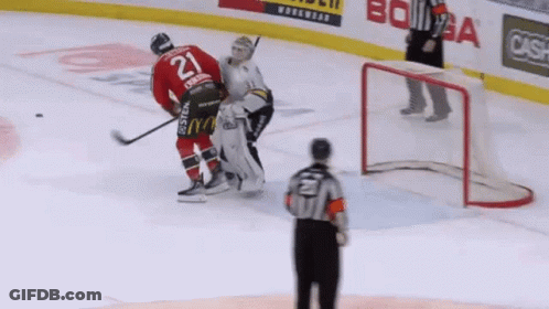 A Hockey Player With The Number 21 On His Jersey Stands On The Ice GIF