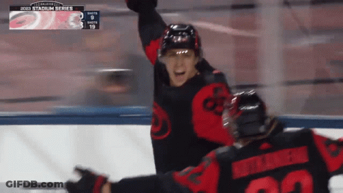A Hockey Player With The Number 22 On His Back Celebrates A Goal GIF