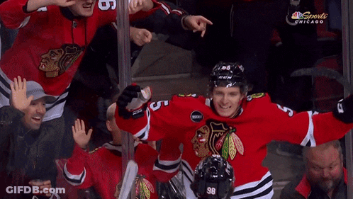 A Hockey Player With The Number 23 On His Jersey Is Hugging Two Other Players GIF