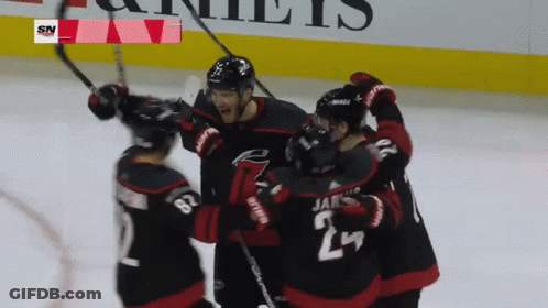 A Hockey Player With The Number 24 On His Jersey Is Surrounded By Other Players GIF