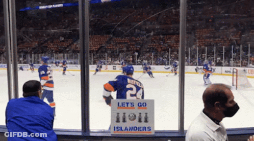 A Hockey Player With The Number 24 On His Jersey Stands In Front Of A Sign That Says Let 'S Go GIF