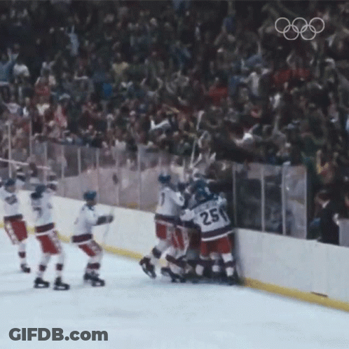 A Hockey Player With The Number 25 On His Jersey Is Surrounded By His Teammates GIF