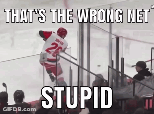 A Hockey Player With The Number 26 On His Jersey Jumps Over A Fence GIF