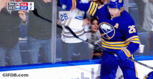 A Hockey Player With The Number 26 On His Jersey Stands On The Ice GIF