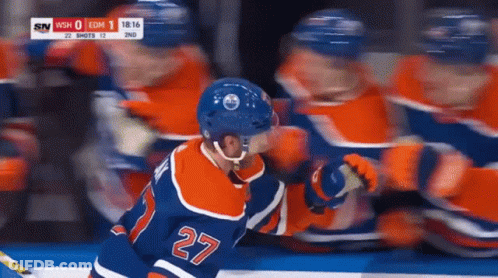 A Hockey Player With The Number 27 On His Back GIF