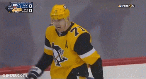 A Hockey Player With The Number 27 On His Jersey Stands On The Ice GIF