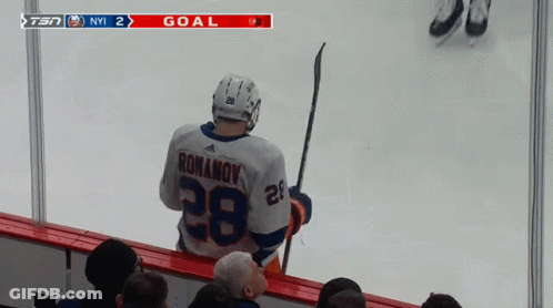 A Hockey Player With The Number 28 On His Jersey Stands On The Ice GIF