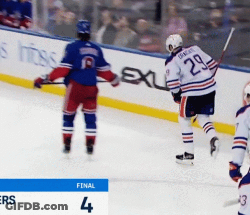 A Hockey Player With The Number 29 On His Back Stands On The Ice GIF