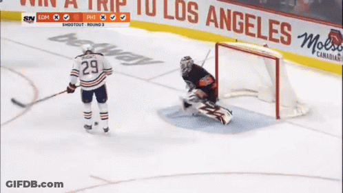 A Hockey Player With The Number 29 On His Jersey Stands On The Ice GIF