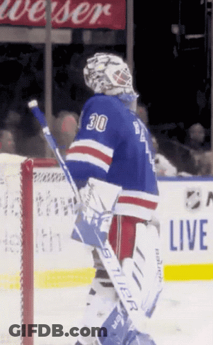 A Hockey Player With The Number 30 On His Jersey Stands On The Ice GIF