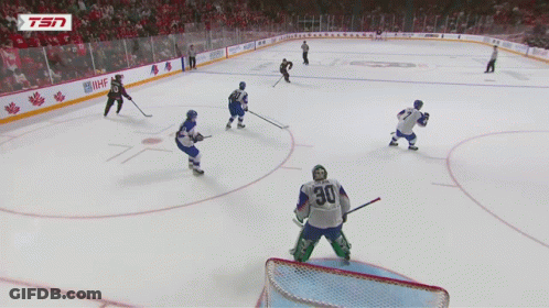 A Hockey Player With The Number 30 On His Jersey Stands On The Ice GIF