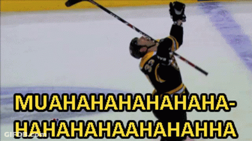 A Hockey Player With The Number 36 On His Jersey Is Holding His Stick In The Air GIF
