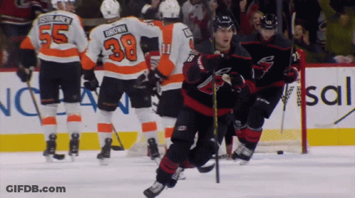 A Hockey Player With The Number 38 On His Jersey Is Skating On The Ice GIF