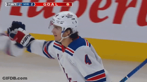 A Hockey Player With The Number 4 On His Jersey Celebrates His Goal GIF