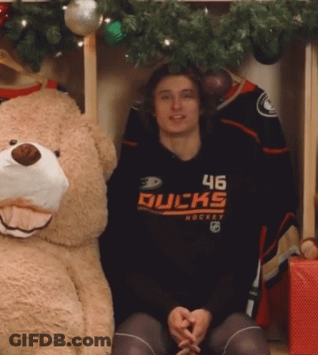 A Hockey Player With The Number 46 On His Shirt Is Sitting Next To A Teddy Bear GIF