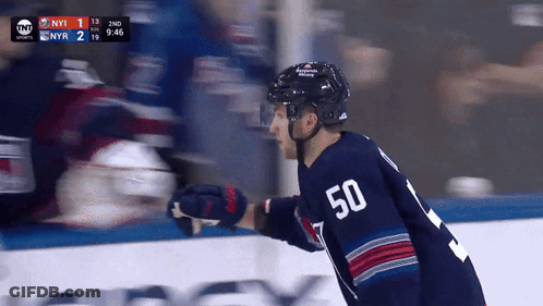 A Hockey Player With The Number 50 On His Jersey Stands On The Ice GIF