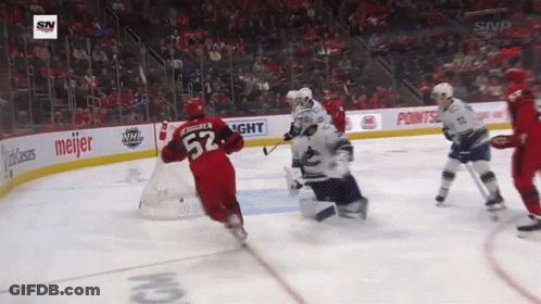 A Hockey Player With The Number 52 On His Jersey Is Skating Around The Ice GIF