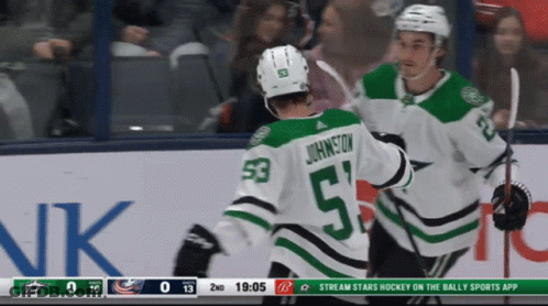 A Hockey Player With The Number 53 On His Back Is Being Hugged By Another Player GIF