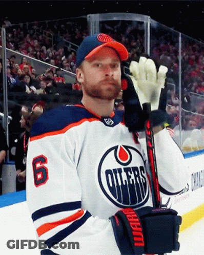 A Hockey Player With The Number 6 On His Jersey Is Holding A Stick GIF