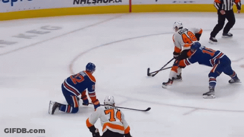 A Hockey Player With The Number 7 On His Jersey Is Kneeling On The Ice GIF