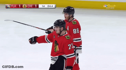 A Hockey Player With The Number 71 On His Jersey Celebrates A Goal GIF