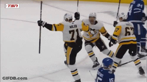 A Hockey Player With The Number 71 On His Jersey Celebrates With His Teammates GIF
