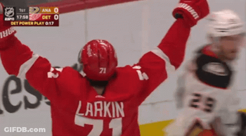 A Hockey Player With The Number 71 On His Jersey Is Celebrating GIF